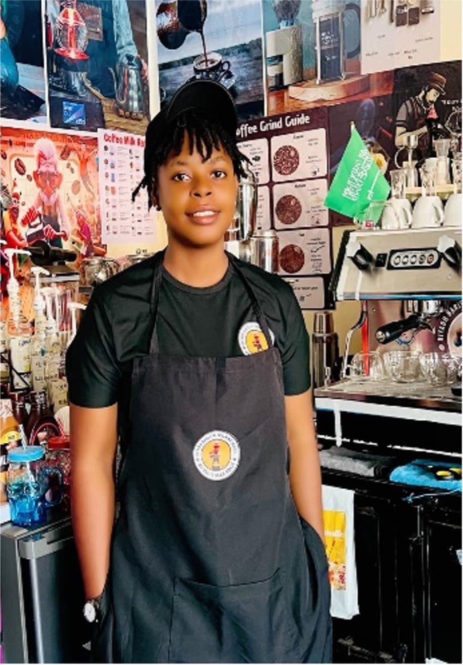 Student behind the counter at Riyadh Barista Training School